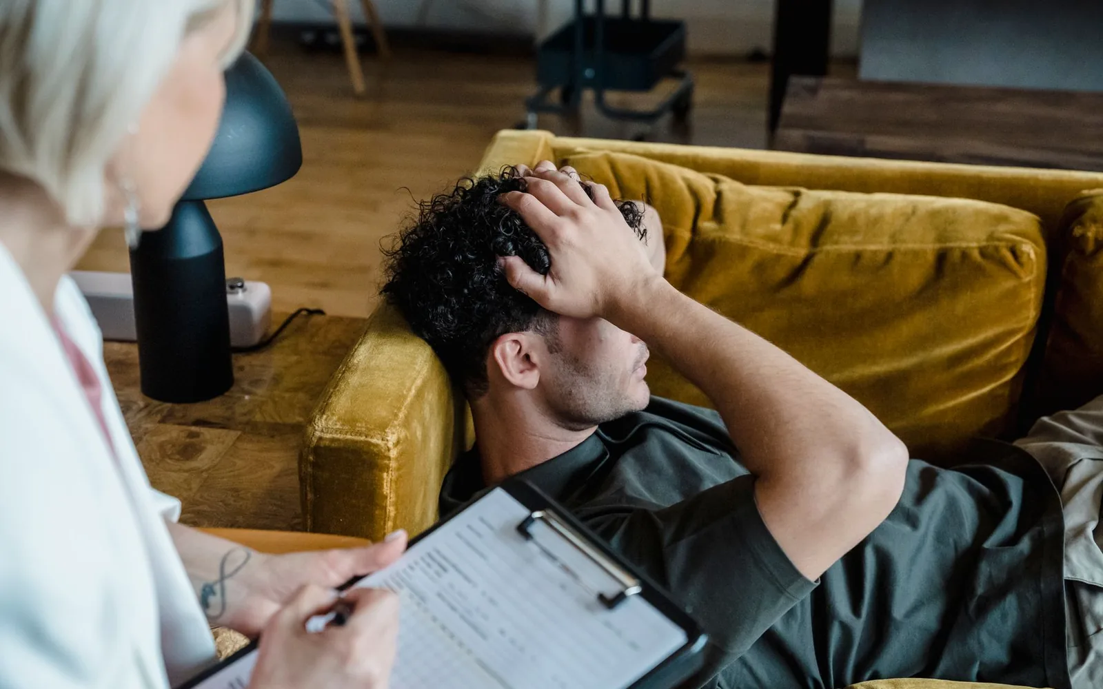 An adult discussing exhaustion and low mood with a mental health professional