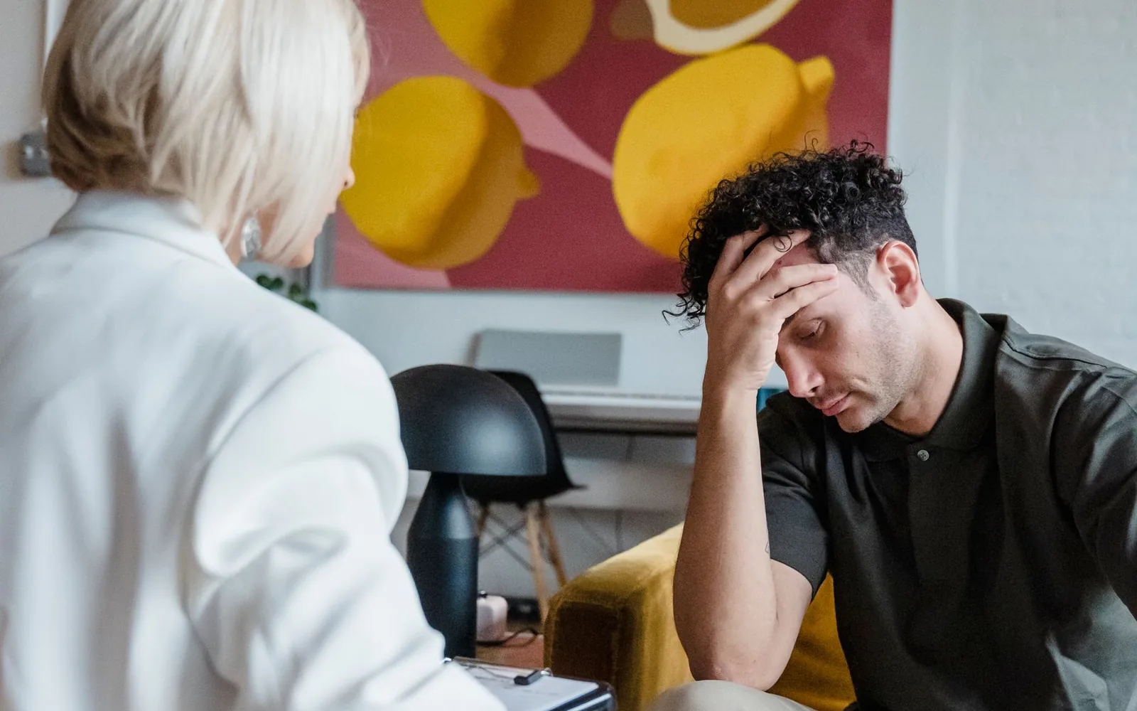 An adult talking with a clinician about unexplained anxiety
